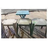 Lot of four plastic patio side tables, one