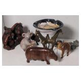 Flat of candles, figurines, and a brass giraffe