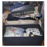 Lot of rugs and throw pillows with storage box on