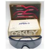 (E)  Oakley Sun glasses and Earpiece Kit