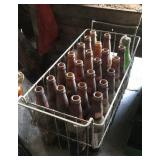 Basket of vintage pop and beer bottles
