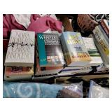 Books including Nora Roberts, leather cleaner,