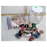 Thread spools, wood clothes pins, glass canister