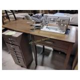 White sewing machine in cabinet, foot pedal,