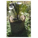 Stump and glass bottle yard art,