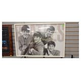 Framed picture of The Beatles with some damage