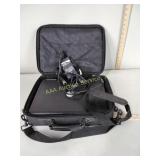 Dell laptop with power cord and case, powers on