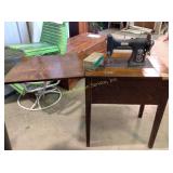 White sewing machine in cabinet come up with