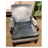 Upholstered chair, with carved arms and legs,