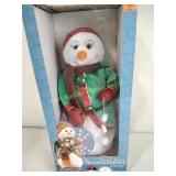 Snowflake spinning snowman plays Santa baby, in