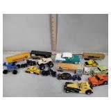 Toy semi trucks including Mac tools, fire stone,