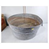 Galvanized tub with rounded bottom and some rust