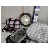 Wall clock, blanket, Eddie Bauer backpack, pet