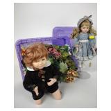 (2) porcelain dolls, artificial flowers, plastic