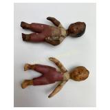 White and African american dolls.  One has a crack