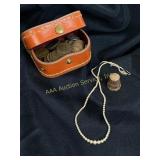 Assortment of Pennies, thimble, and necklace