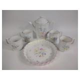 coffee pot with matching mugs and pastry tray,