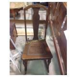 Rocking chair with cane seat. Some damage.