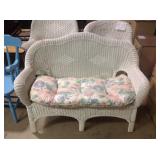Wicker settee. Minor paint wear and cushion