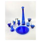 Cobalt blue glassware: bottle, plate, candle