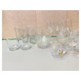 Clear glassware including wine glasses, whiskey