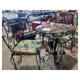 Wrought iron cafe table very ornate, two chairs