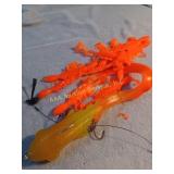 Large rubber fishing lure and small orange