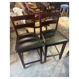 Pair of tall wooden chair with leather cushions,