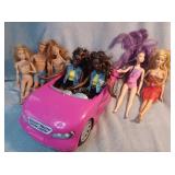Barbie dolls, Ken doll, and Barbie convertible