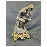 "The Thinker" statue, chipped, hole in leg,
