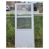 Metal storm door with screen and glass panels,