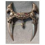 double knife with heart in middle