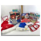 Variety of storage tins, Santa hats, doll