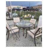 outdoor metal and glass dining table with 4 metal