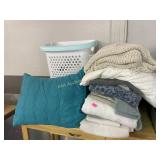 White roller hamper with a various pillows,