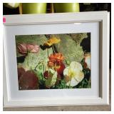 Framed floral photographs in white frames and