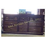 Brown 9 drawer dresser. Solid wood. some dents and