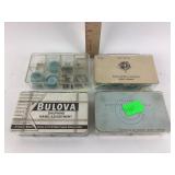 Assorted Bulova watch parts in small cases.