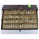 Assorted watch parts within four drawer metal