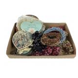 Brass framed floral and people pictures.