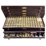 Watch crystals, other parts in metal cabinet with