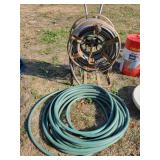 Free standing rolling hose reel with hose, garden