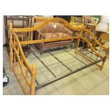 wooden daybed frame with a warm honey finish,