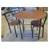 dinette set with a round table and two matching