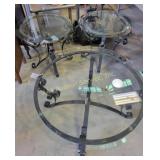 Round glass-top table set with wrought iron