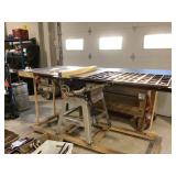 Craftsman table saw, on handmade wheeled base.