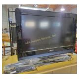 flat-screen TV - powers on,  ideal for any room.