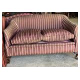 sofa with striped upholstery in shades of mauve