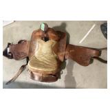 well-worn vintage Western saddle with rustic