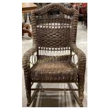wicker rocking chair with a curved back and